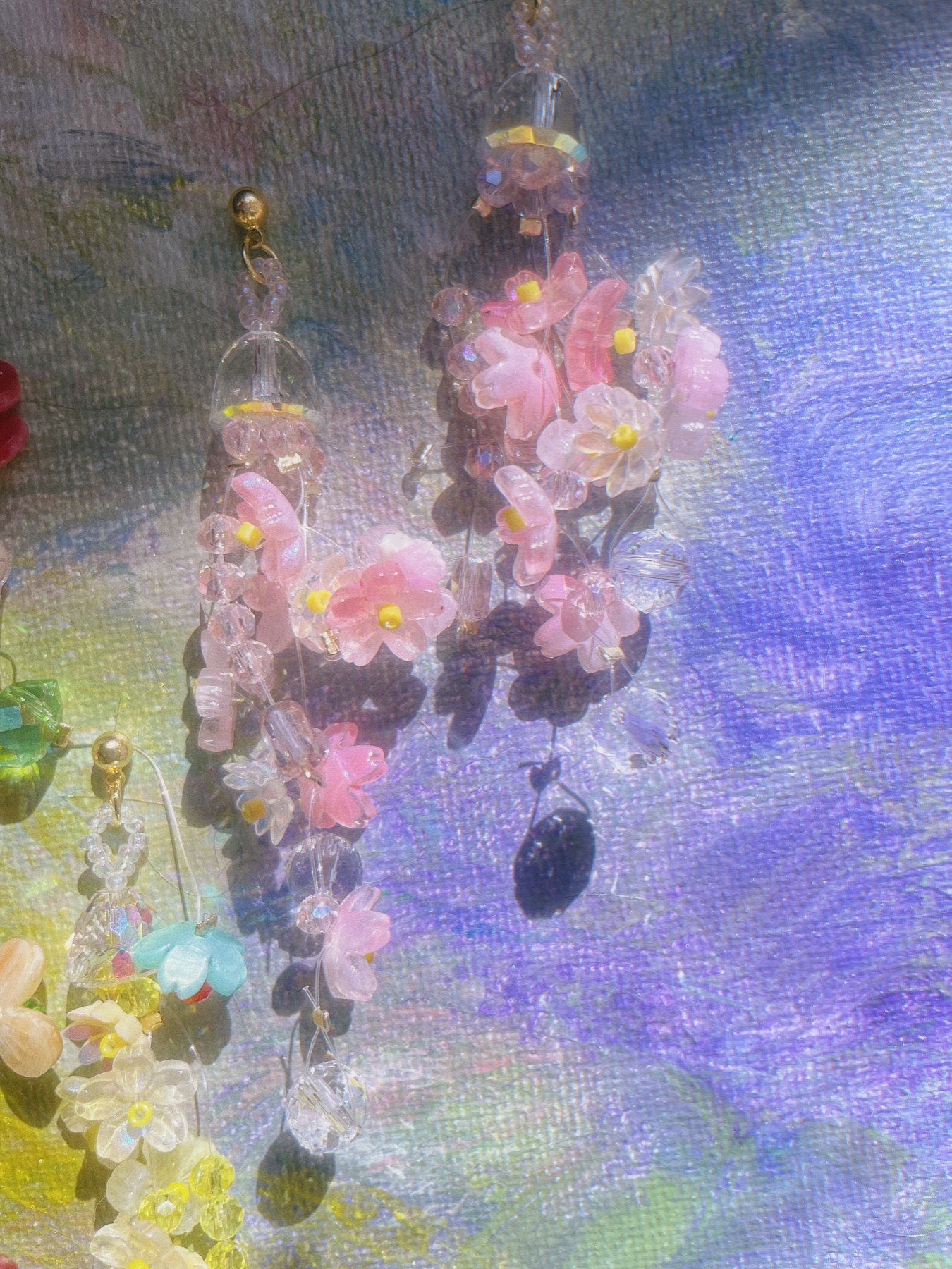 Pink blossom earrings in soft violet light